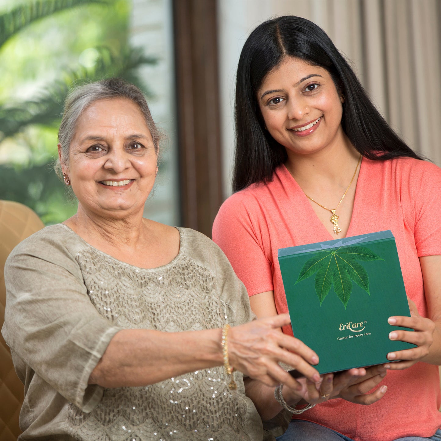 Grandmother and young lady holding EriCare Castor Oil Kit, promoting eranda oil application for beautiful strong long fuller shinier hair